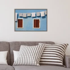 Amanti Art Hanging Laundry Along Blue Wall Framed Canvas by Brenda Tharp 15 Amanti Art Hanging Laundry Along Blue Wall Framed Canvas by Brenda Tharp -Amanti Art Shop GUEST 641a5143 6445 4421 99af 7eae912e9794