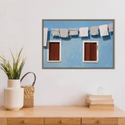 Amanti Art Hanging Laundry Along Blue Wall Framed Canvas by Brenda Tharp 14 Amanti Art Hanging Laundry Along Blue Wall Framed Canvas by Brenda Tharp -Amanti Art Shop GUEST b20649a9 7fba 4d02 af4d d13fe3f2b1de